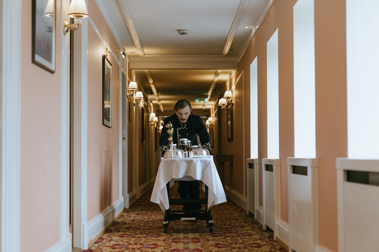 The Art of Drawing Readers In: Your attractive post title goes here A hotel staff member pushes a room service trolley in a luxurious corridor.